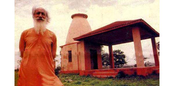 Fr. Peter Julia in front of a Church in the shape of Shiva Linga